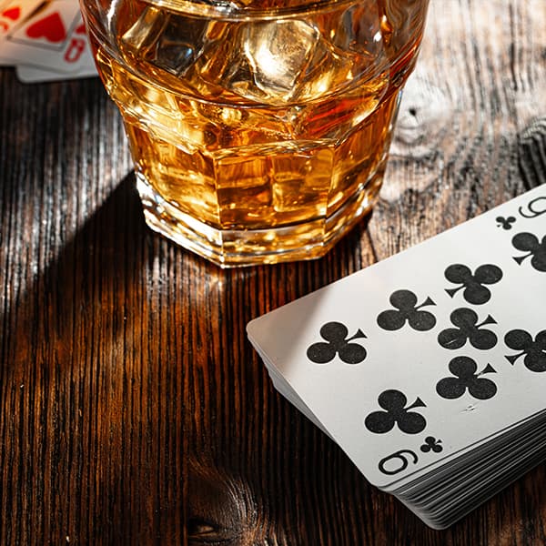 Whiskey and cards on a table