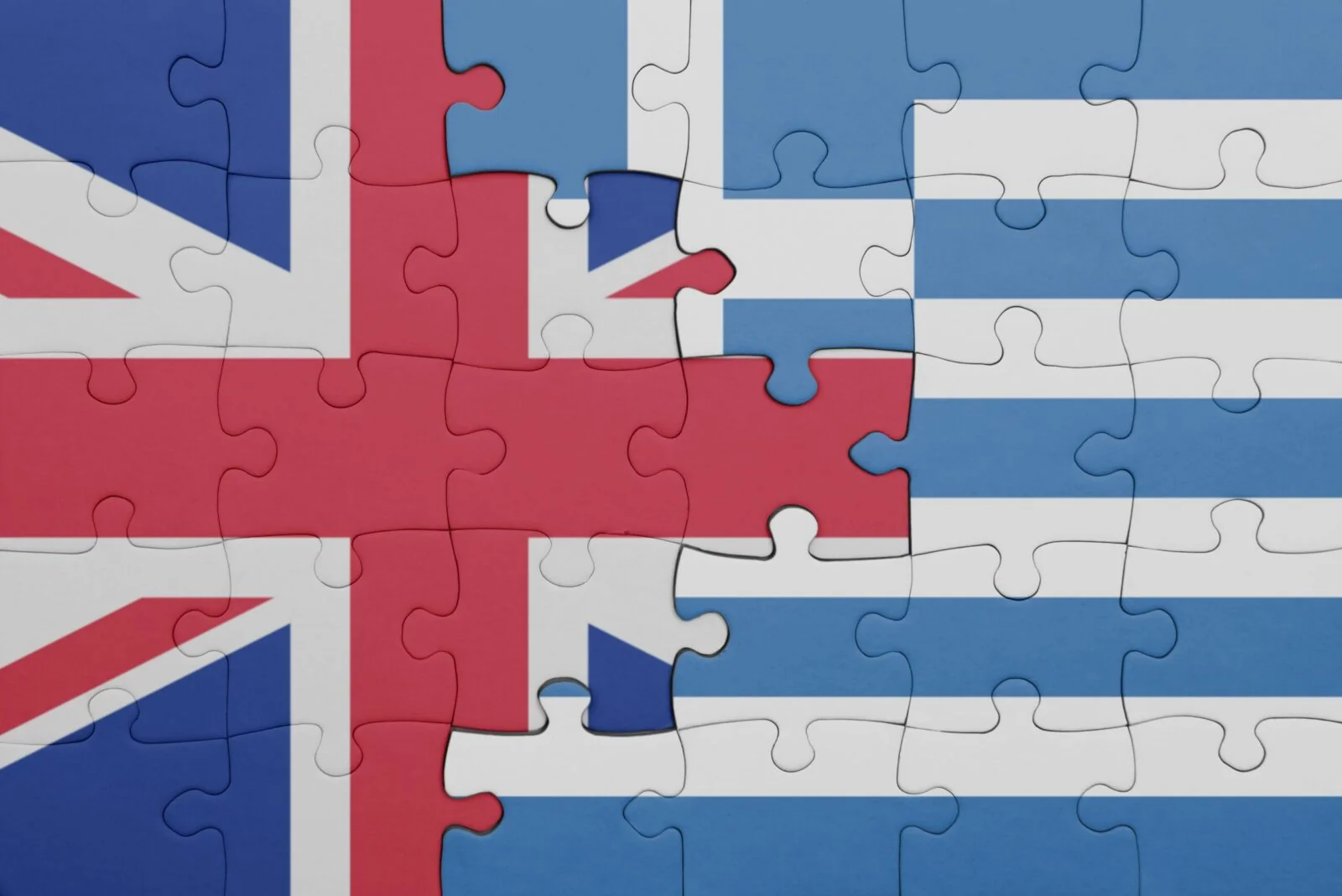 The Greek Tax Incentives Putting Greece on the Radar of Wealthy British Households Union Jack and Greek flag joined as jigsaw pieces, representing UK households planning tax residence in Greece