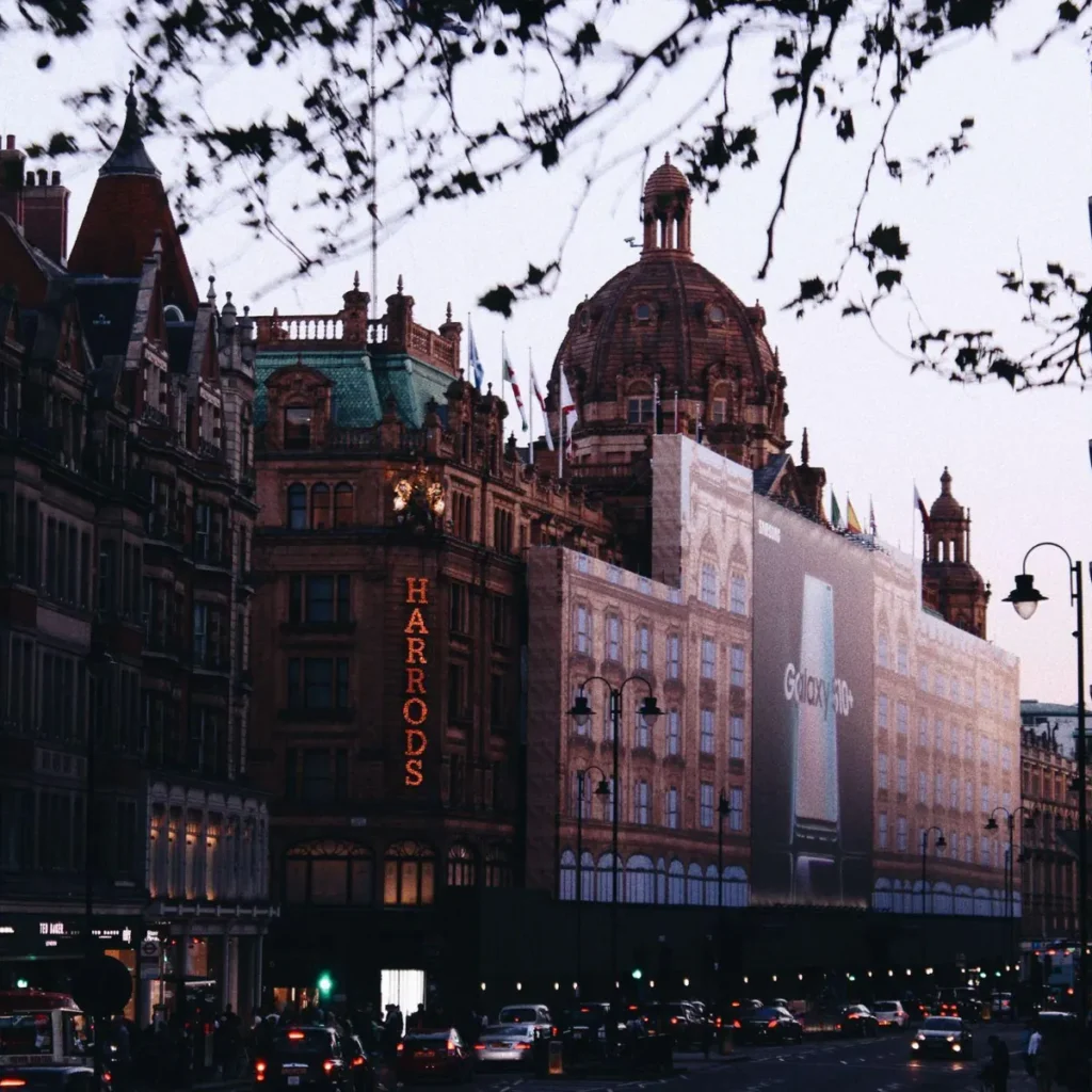 Best Areas to Look for Flats in London If You Want Access to Mayfair’s Lifestyle Scene Harrods department store on Brompton Road in Knightsbridge at dusk
