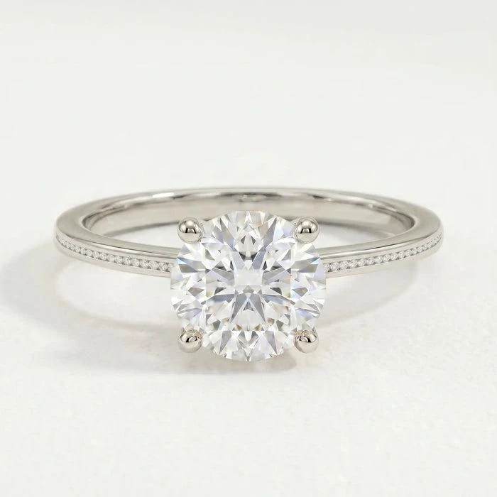 Iris engagement ring in 18ct white gold with a round lab-grown diamond in a four-claw setting and petite channel-set shoulders