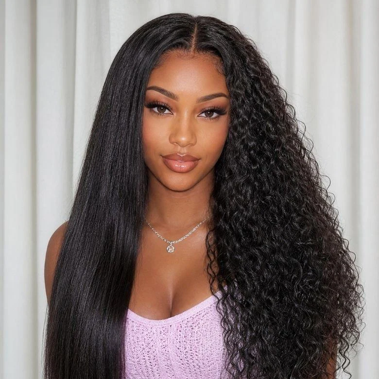 Woman with long dark hair worn straight on one side and in tight curls on the other, in a lilac knit top